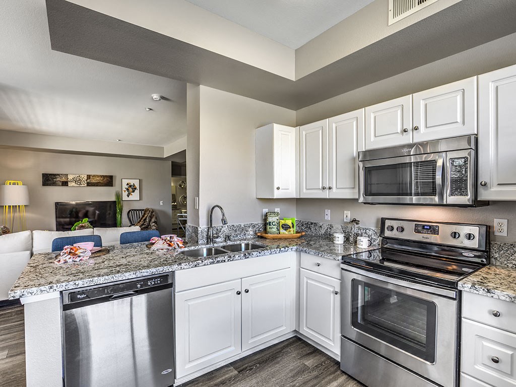 a kitchen with stainless steel appliances and granite counter tops