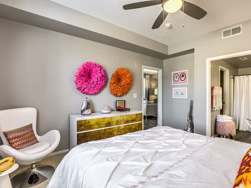 a bedroom with a bed and a ceiling fan