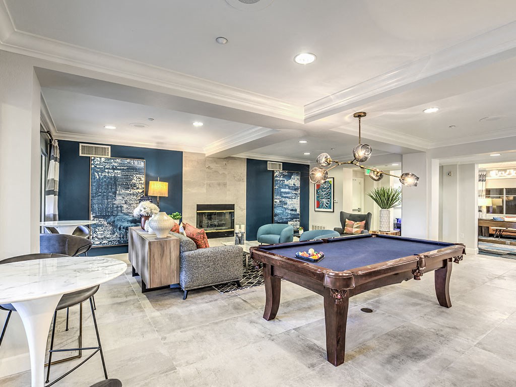 a game room with a pool table and a fireplace