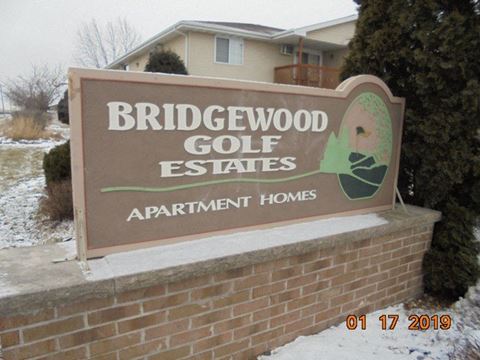 a sign for the bridgewood golf estates apartment homes