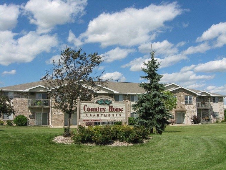the community home apartments sign in front of a building