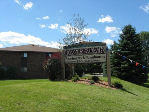 a sign for daybreak apartments and townhomes in front of a building