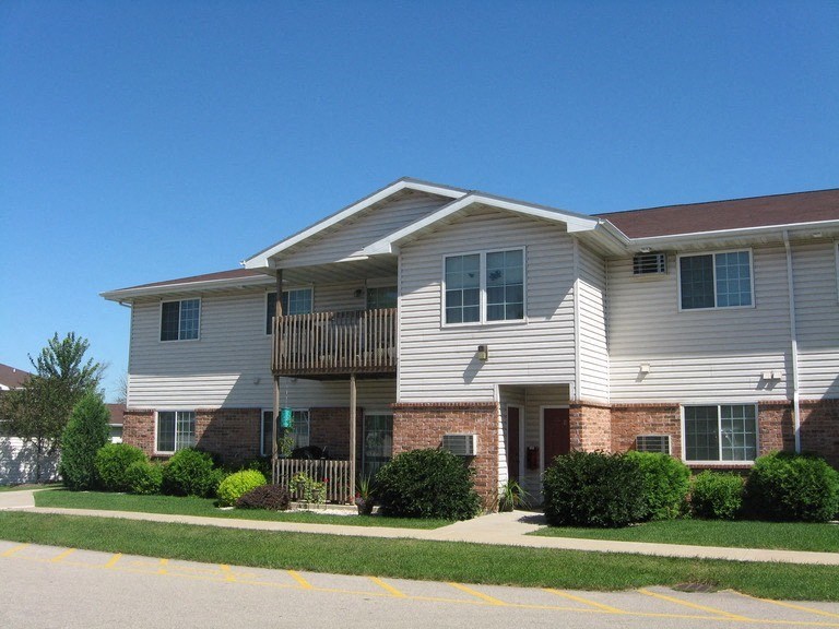 a white house with a balcony on a street