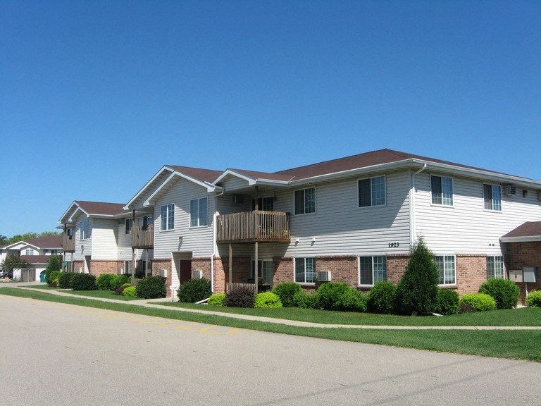 an apartment building with a street in front of it