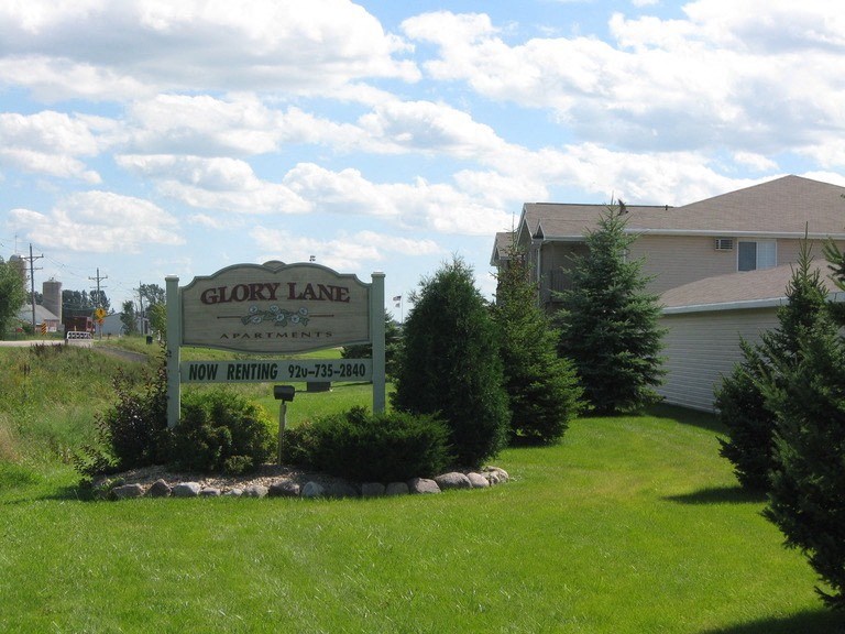 a sign forglow land in front of a house