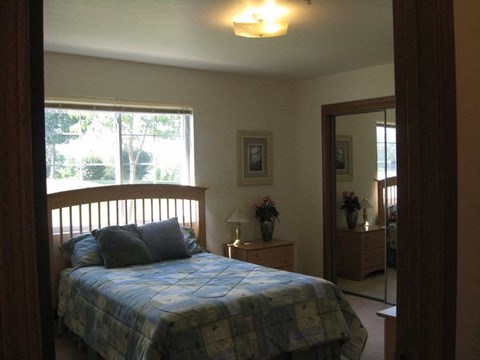 a bedroom with a bed and a mirror