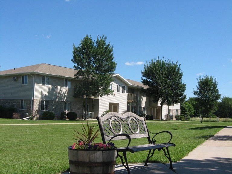 a park bench sitting in front of a house