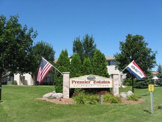 a sign for premier estates in front of a building