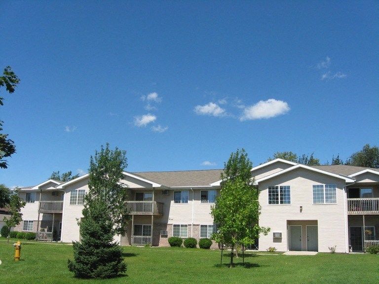 an apartment building with trees in front of it