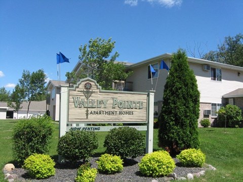 a sign for the valley pointe apartments sign in front of a building