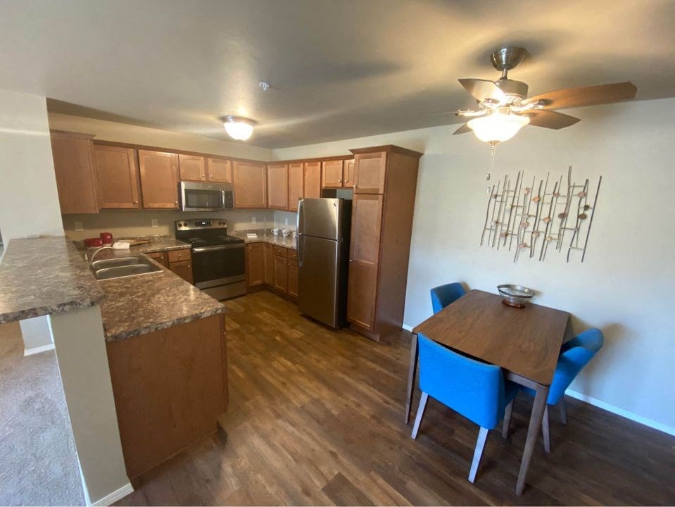 a kitchen and dining area with a table and a refrigerator