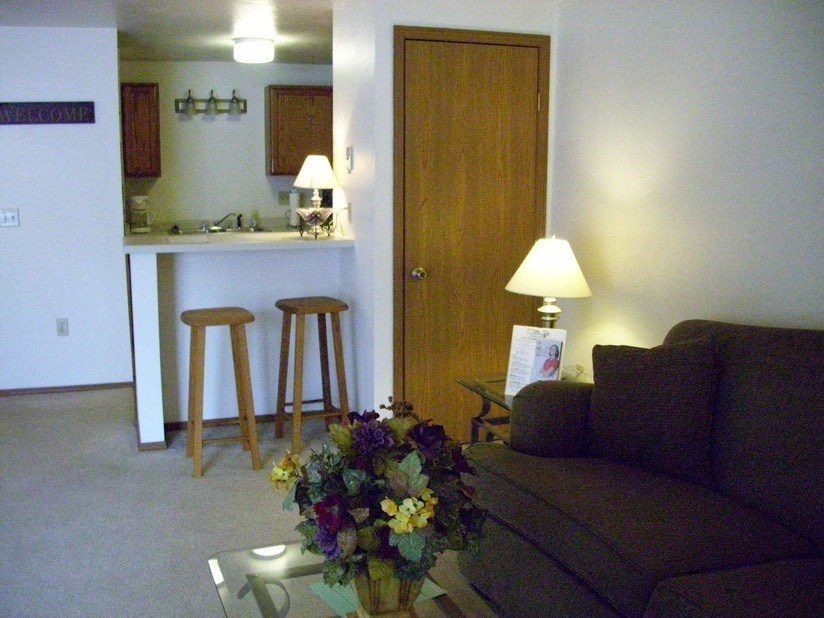 a living room with a couch and a table with flowers