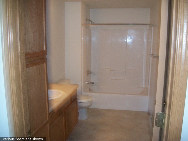 a bathroom with a toilet and a sink and a shower