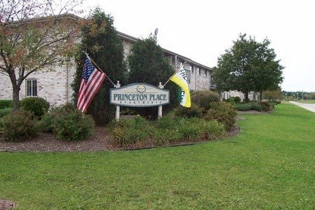 a building with a sign and flags in front of it