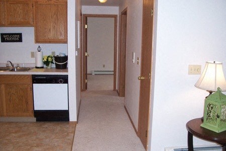 a kitchen and a hallway with a sink and a door