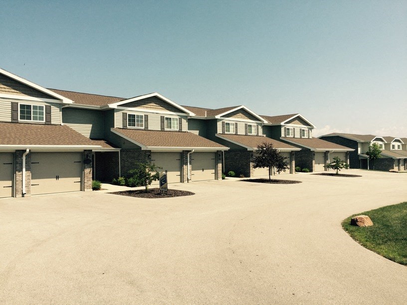 a row of houses on a dirt road