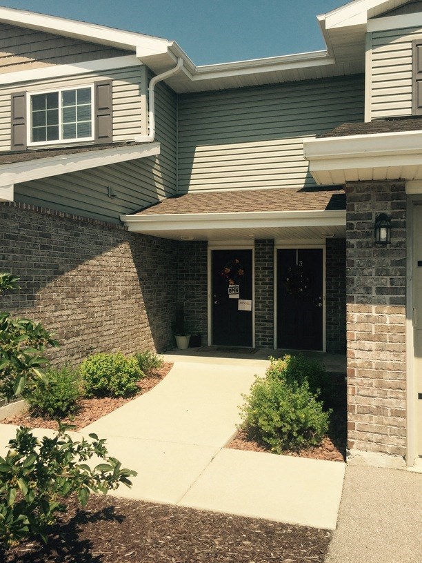 a house with a sidewalk in front of it