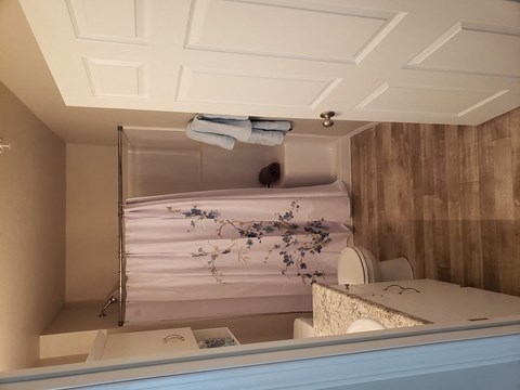 A bathroom with a towel hanging on the towel rack.