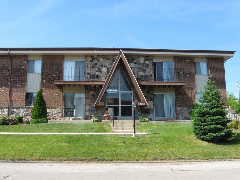 a building with a triangular sign in front of it