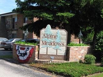 a sign for alpine meadows in front of a building