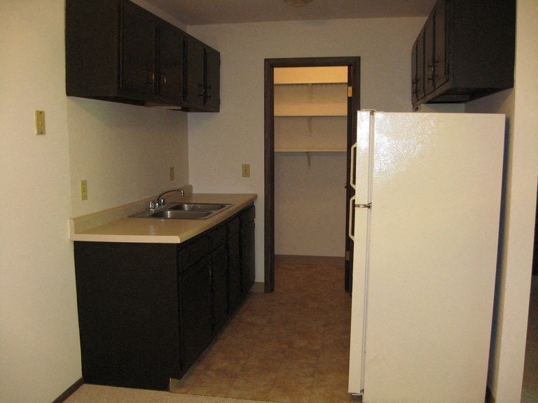 a kitchen with a sink and a refrigerator
