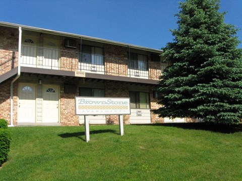 an apartment building with a sign in front of it