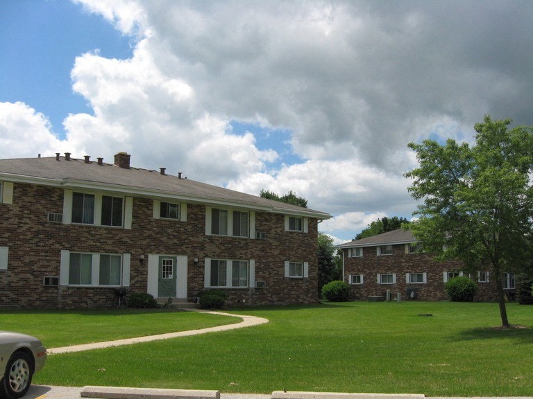 a car parked in front of a brick house