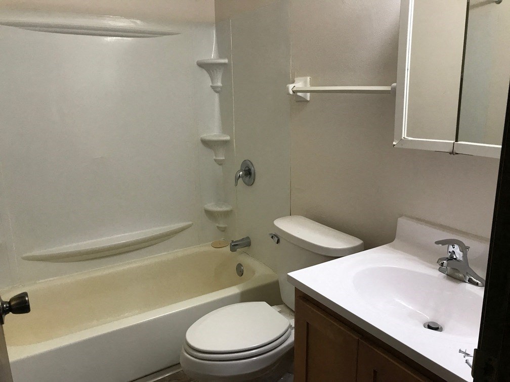a bathroom with a sink toilet and a bath tub