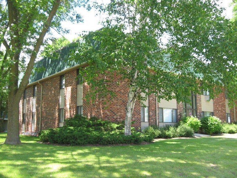 a large brick building with trees in front of it