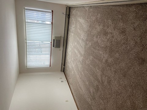 a small room with a window and a wall