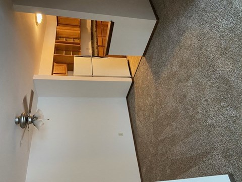 a view of a room from the top of a staircase
