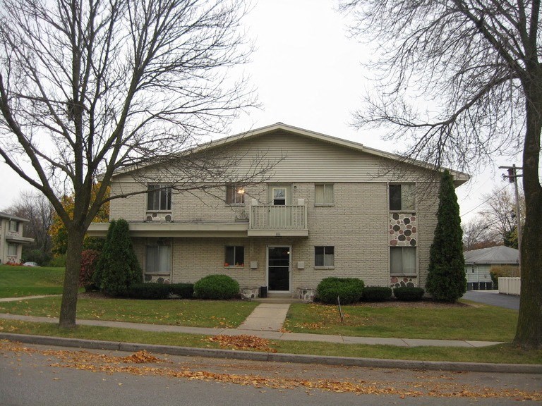 A two-story house with a garage on the ground floor.