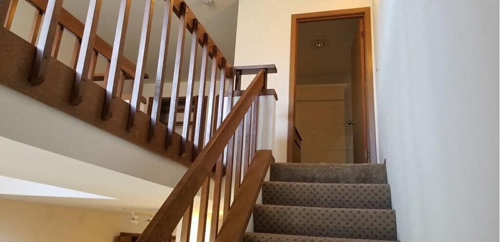 a staircase in a house with stairs and a door