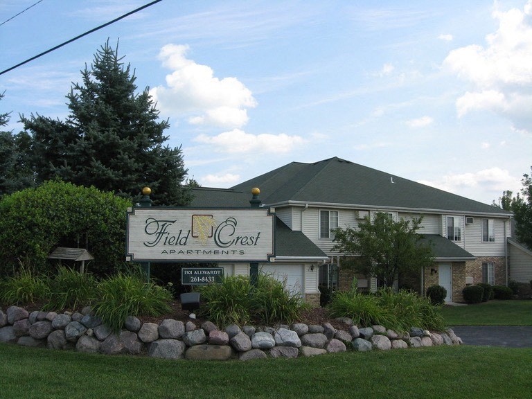 the field creek restaurant sign in front of a white house