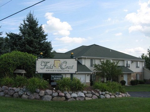 the field creek restaurant sign in front of a white house