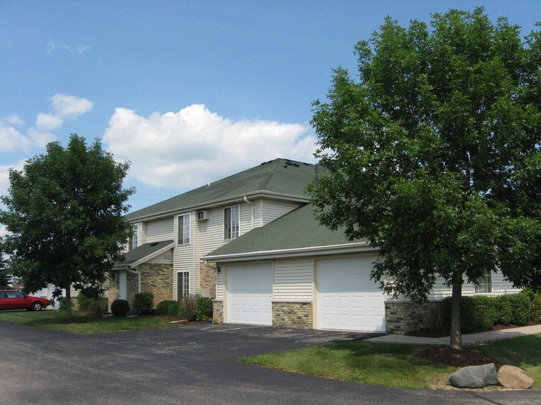 a white house with trees in front of it
