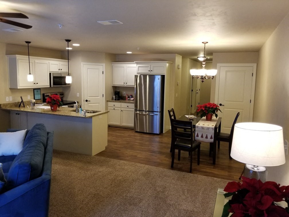 an open living room and kitchen with a table and chairs