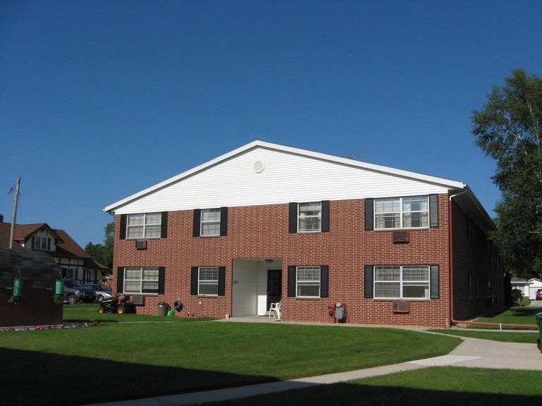a red brick house with a white roof