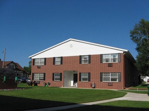 a red brick house with a white roof