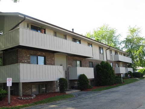 an apartment building with a street in front of it