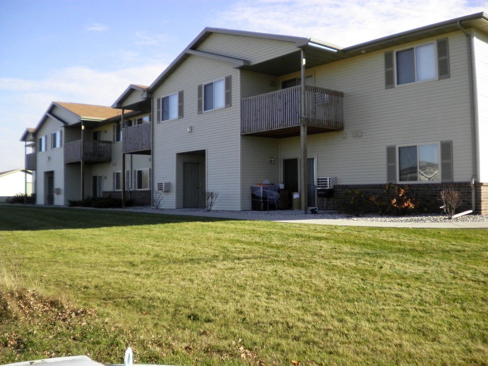 an apartment building with a yard in front of it