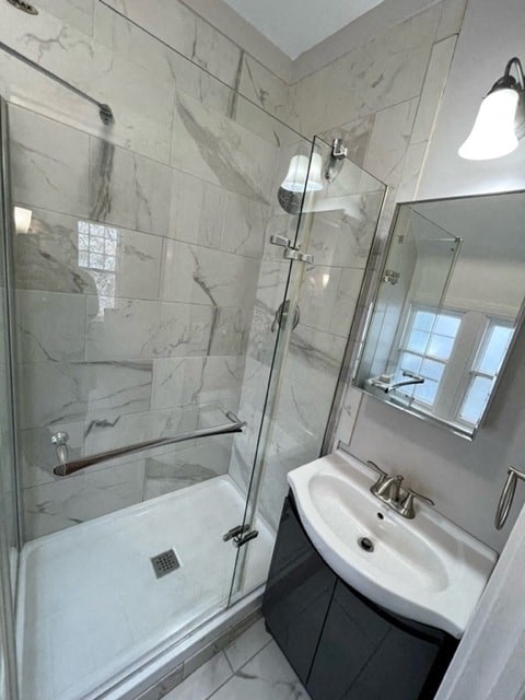 a bathroom with a shower and a sink and a mirror
