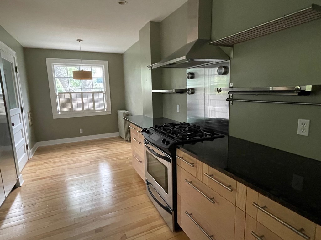 a kitchen with a stove and a window
