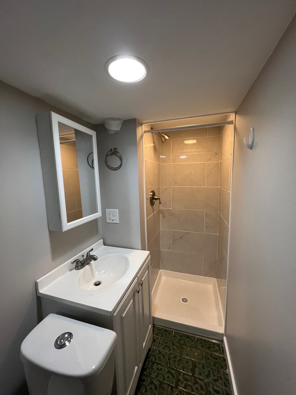 a small bathroom with a sink and a shower
