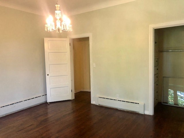 an empty living room with a wooden floor and a white door