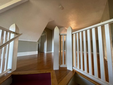 a view from the top of a staircase in a home with wood floors