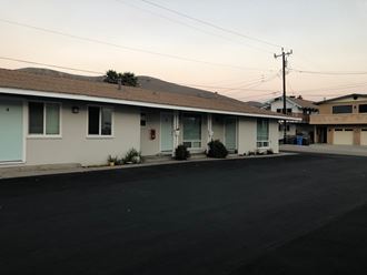a white house with a street in front of it