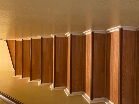 A staircase with wooden steps and a white balustrade.