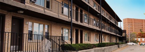 A street view of a building with a car parked in front.