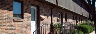 a brick building with a balcony and a door